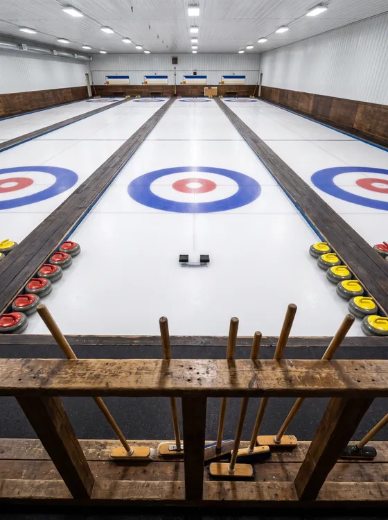 Empty curling rink with four sheets of ice